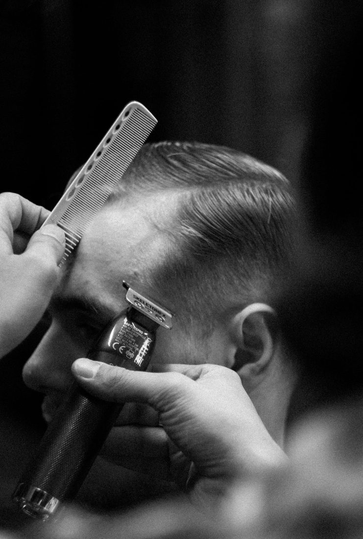 Clipper fade being cut close to the ear