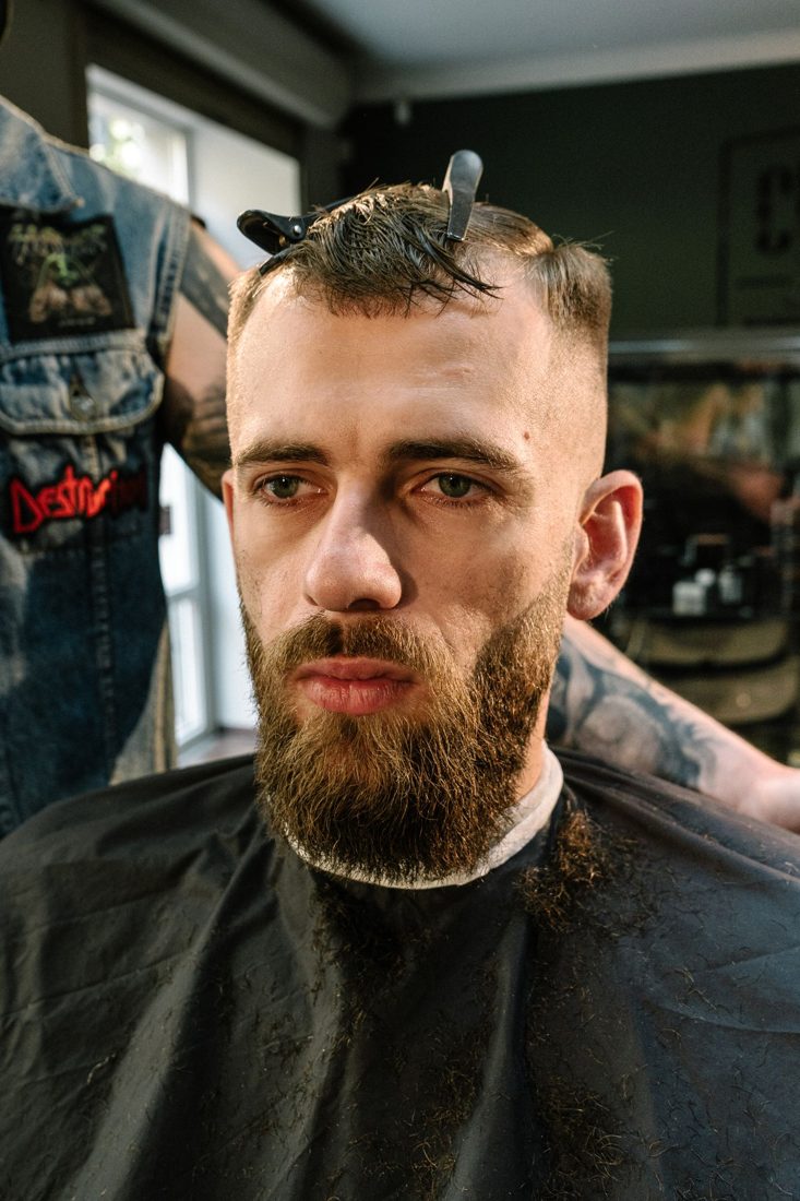 Barber shaping a fade haircut