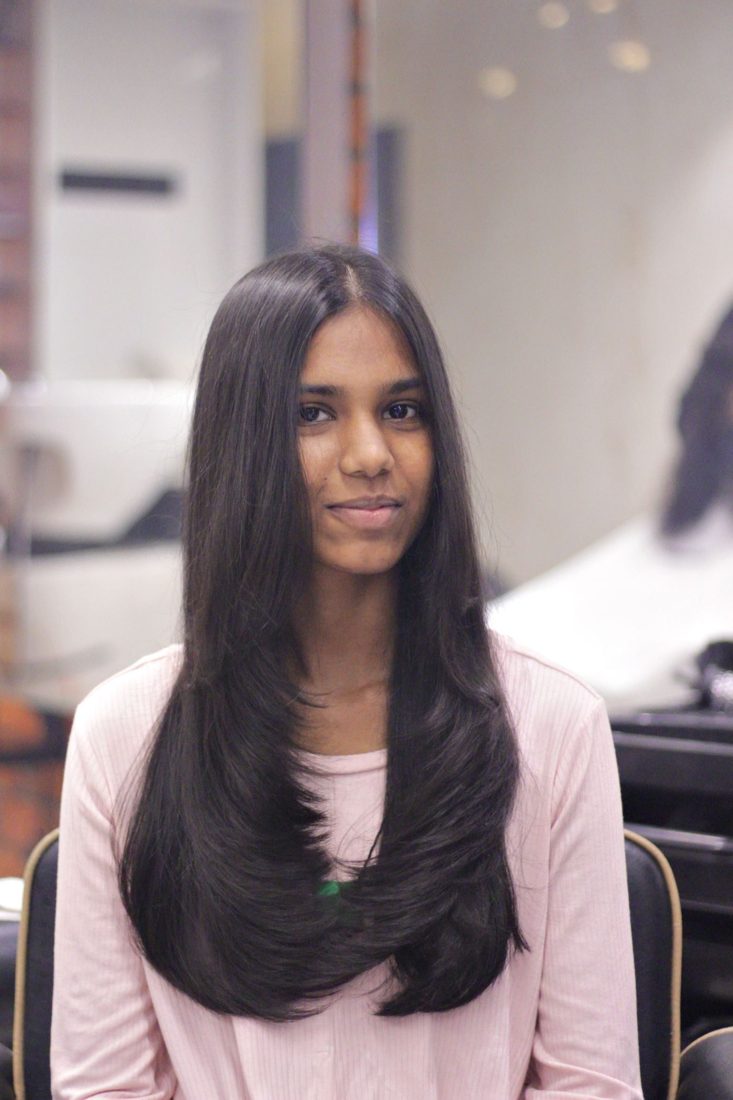 Woman with long layered straight hair